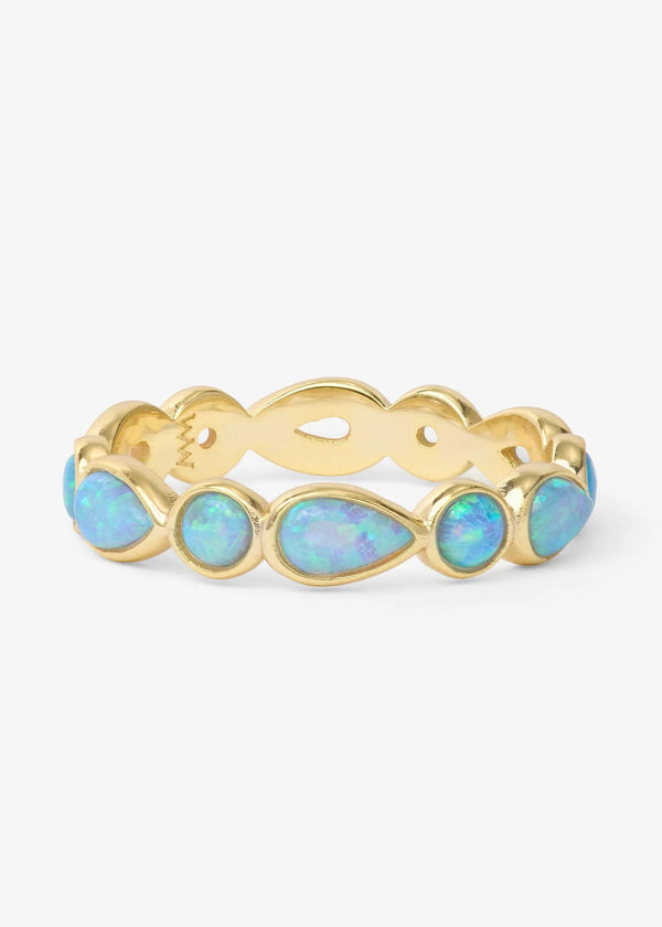 Gold ring with opal stones on a white background