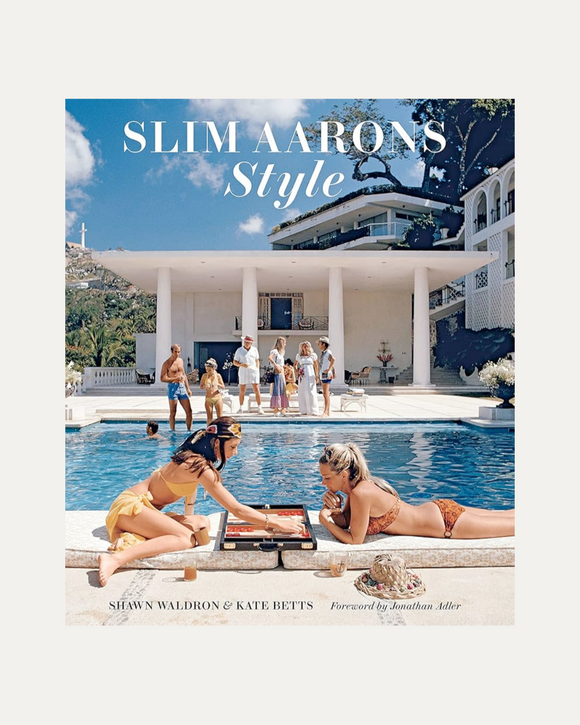 Book cover of 'Slim Aarons Style' with people by a pool and a house in the background.